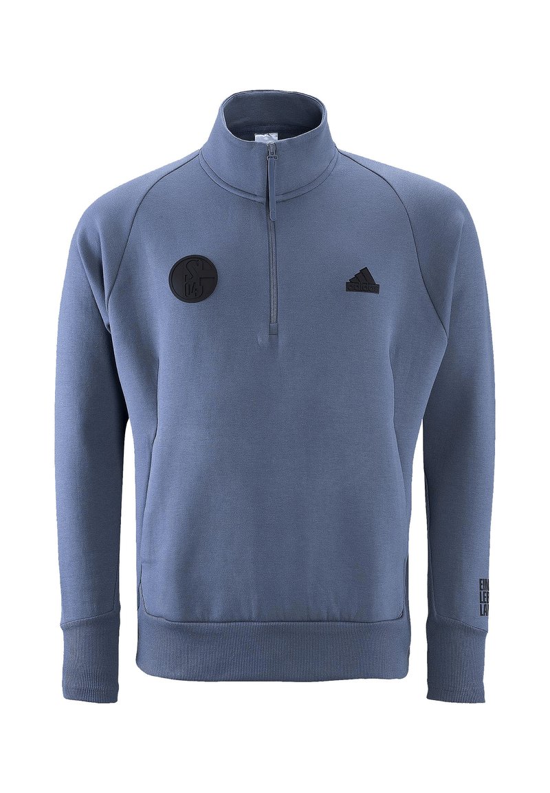 Pullover in pile blu con zip a quarto, polsini e orlo a costine. Presenta un'etichetta con logo nero e la scritta "EIN LEHR." Testo sull'accento del maniche sinistra.