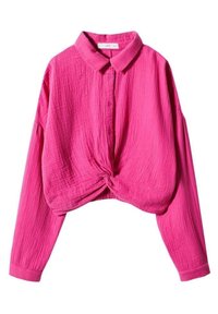 Chemise fuchsia avec col boutonné, manches longues et devant noué. Confectionnée en tissu texturé, elle présente une coupe ample et courte.