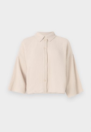 Korte mouwen, knoopsluiting overhemd in een lichtbeige, gekreukt materiaal. Beschikt over een puntige kraag en losse, brede mouwen voor een relaxte pasvorm.