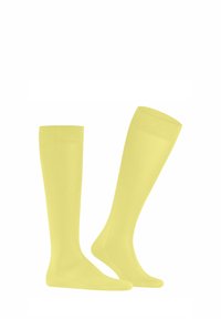 Calze fino al ginocchio di un giallo brillante. Realizzate in un tessuto liscio e elastico con un design semplice e polsini a coste. Senza motivi o dettagli in metallo.