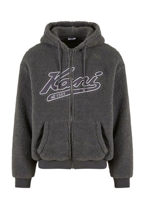 Gray, plush fleece hoodie with a front zipper, two side pockets, and a drawstring hood. Features bold "Kani" logo on the chest.
