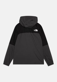 Juoda ir tamsiai pilka gobtuvo striukė su ilgomis rankovėmis, elastingomis rankogaliais ir "The North Face" logotipu ant viršutinės nugaros dalies. Lengvas, lygus paviršius.