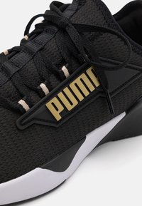 Puma Chaussures de running sur route - gold-coloured