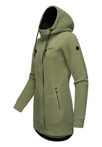 Fleece jacket in olive green. Features a hood, zippered pockets, black accents, and textured fabric. Front zip closure and long sleeves.