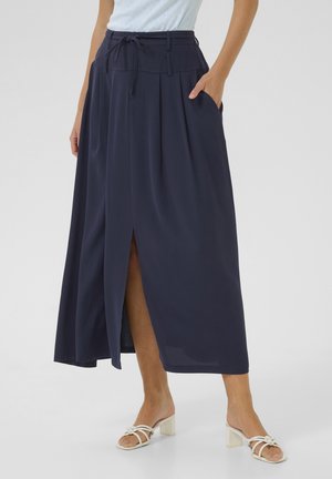 Jupe maxi plissée bleu marine avec taille haute, cordon de serrage, poches latérales et fente à l'avant. Tissu léger et fluide.