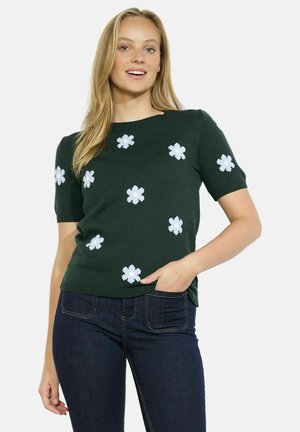 Green short-sleeve sweater made of knit fabric, featuring white floral appliqués across the front, with a round neck and ribbed edges.
