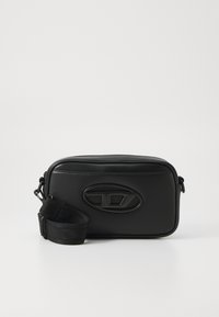 Black leather shoulder bag with a rectangular shape, a textured surface, embossed logo, and an adjustable strap. Zipper closure at top.