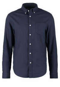 Mörkblå långärmad knäppskjorta i bomull med krage, frampocket och vita knappar längs plaggskärningen.