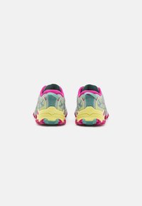 Metsajooksu jalanõud, millel on võrksüsi türkiissinisest ja roosast, kollane pehmendusega tallaga, millel on punased haardelugesid, loodud haarde ja mugavuse tagamiseks.