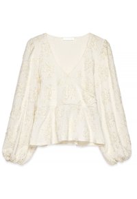 Blusa bianca a peplo con scollatura profonda a V, tessuto testurizzato, maniche lunghe a sbuffo e ricami floreali su tutta la superficie.