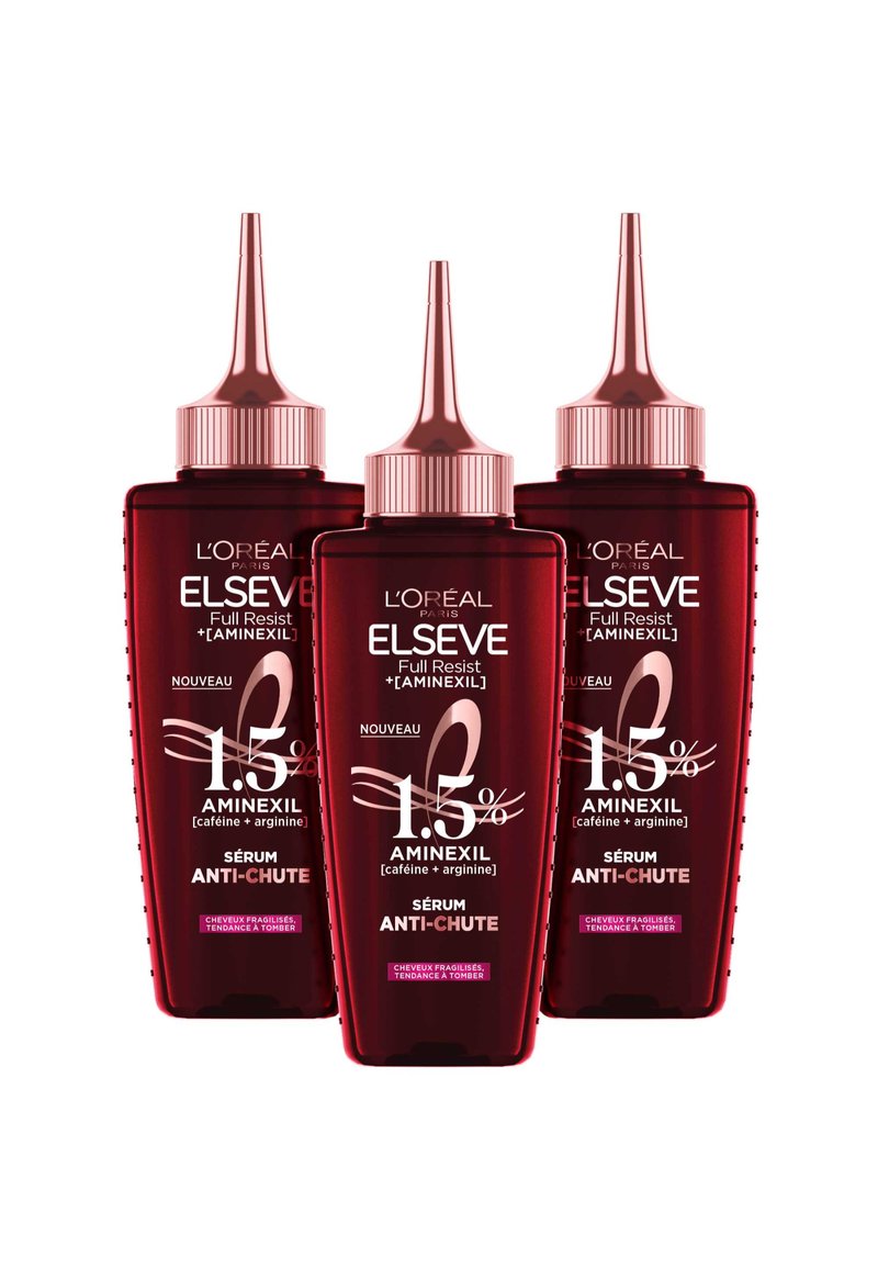 Trois bouteilles de sérum L'Oréal Elseve rouges avec des compte-gouttes pointus. Chaque bouteille présente des textes en blanc et rose, mettant en avant les ingrédients et les instructions d'utilisation.