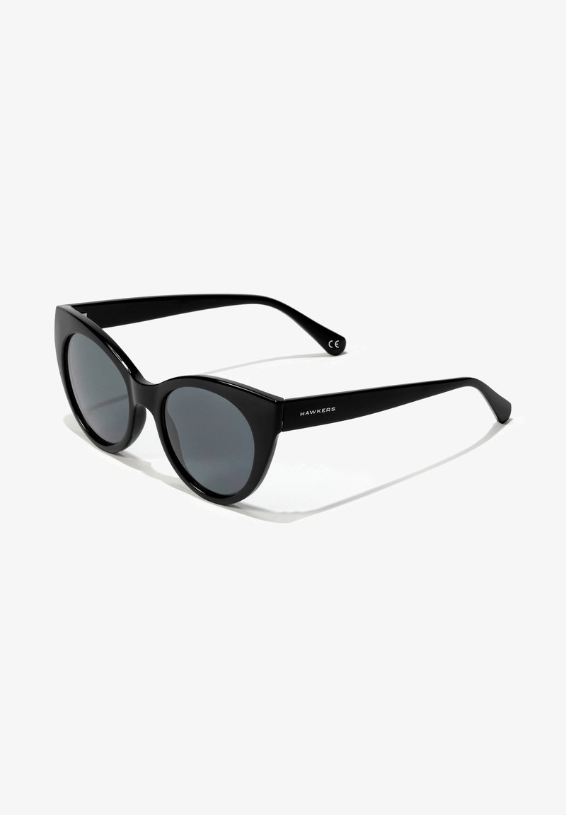 Cat-eye sunglasses with black plastic frames, gray tinted lenses, and smooth finish. Features logo on the left arm and curved temples.