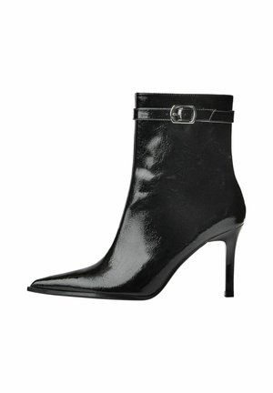 Black high-heeled ankle boot with a glossy leather finish, pointed toe, and a narrow strap with a silver buckle at the ankle.