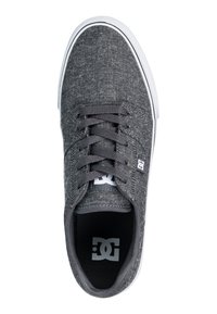 Gray canvas sneaker with a textured upper, lace closure, and white rubber sole. Features logo on the tongue and a padded collar for comfort.