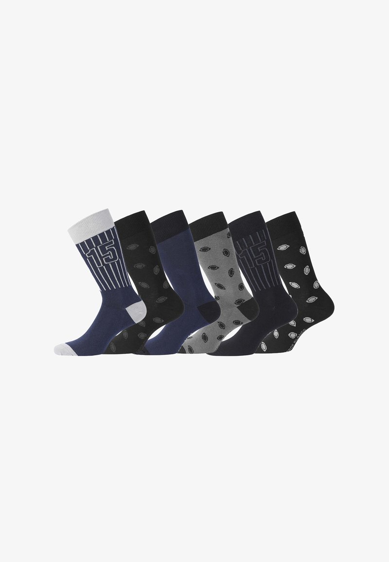 Six paires de chaussettes, avec divers motifs incluant des rayures et des pois. Les couleurs comprennent le bleu foncé, le gris, et le noir avec une texture en coton.