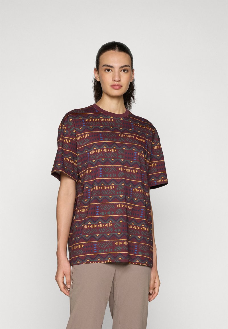 Short-sleeve, maroon patterned t-shirt with geometric designs in blue, yellow, and green. Soft texture, relaxed fit, crew neckline.