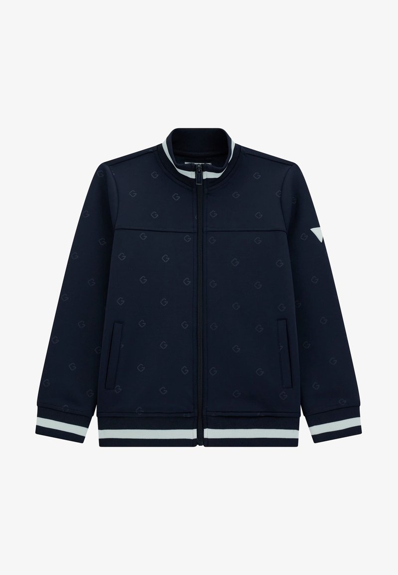 Mornarska športna jakna z zadrgo spredaj, rebrastim ovratnikom, belimi črtastimi manšetami in diskretnim vzorcem logotipa po celotni površini. Ima stranske žepke.