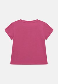 Kortærmet, rundhalset t-shirt i ensfarvet pink bomuld. Glat tekstur med en lige syning og ren syning. Ingen mønstre eller accenter.