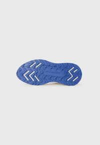 Blue rubber outsole with zigzag tread pattern, featuring white accent lines and embossed brand logo. Suitable for athletic use.