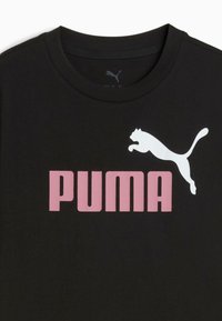 Black cotton t-shirt with a crew neckline, featuring a large white leaping Puma logo and pink “PUMA” text in bold font.