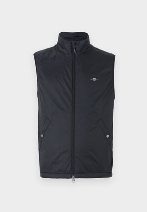 Schwarze ärmellose Weste aus leichtem, glattem Material mit einem hohen Kragen, einem Front-Reißverschluss und zwei seitlichen Taschen mit Druckknöpfen.