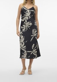 Robe midi en satin bleu marine à motif floral blanc, bretelles spaghetti réglables et fentes latérales pour faciliter les mouvements.