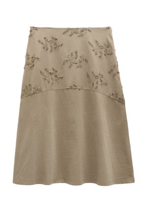 Beżowa spódnica w kształcie litery A z wypukłą haftowaną górną połową z motywem kwiatowym i gładkim materiałem na dolnej połowie.