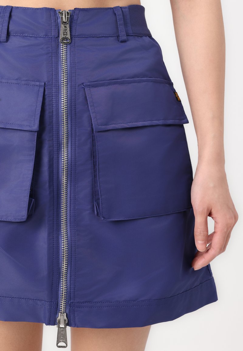 Navy blue cargo skirt made from a shiny, lightweight material. Features front zip closure, two patch pockets, and stitching details.