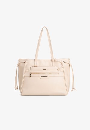 Beige leren tote bag met twee handvatten, een voorvak met rits en zijkanten met trekkoorden.