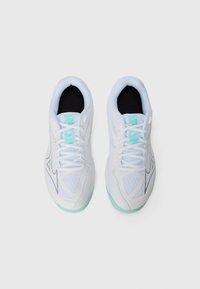 White athletic shoes with a mesh upper, turquoise accents, and a black inner lining. Features include laces and a textured sole.