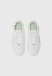 White athletic shoes with a smooth leather upper, mint green insole, traditional lace-up design, and subtle perforations on the toe.