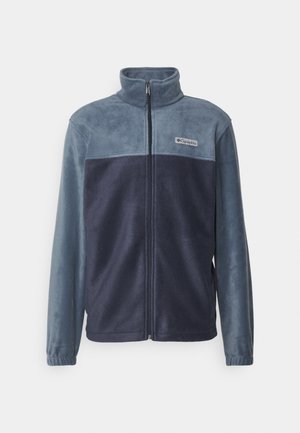 Fleece jacket in blue shades with a full zipper, high collar, and a logo patch on the chest. Soft texture; long sleeves with elastic cuffs.