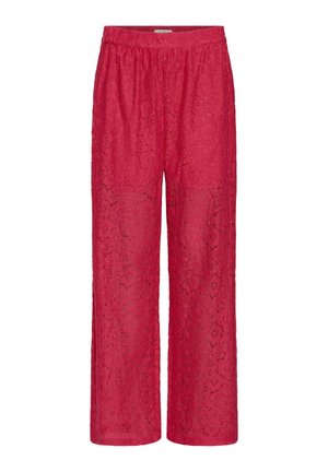 Pantaloni rossi in pizzo con vita elastica, gambe larghe e motivi floreali su tutta la superficie. Il tessuto sembra leggero e semi-trasparente.