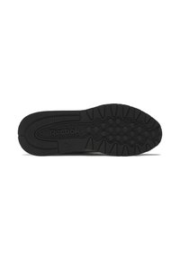 Suela negra de zapatilla Reebok con un patrón de tracción hexagonal y el texto "HEXALITE+" sobre un fondo blanco.
