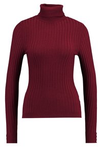 Bordeaux ribbattu turtleneck-paita pitkillä hihoilla, jossa on tiukka siluetti ja teksturoitu neulekuvio.