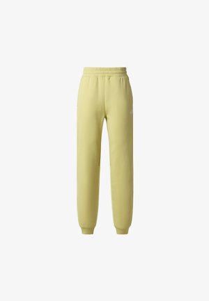 Pantalones deportivos entallados de color amarillo claro con cintura y puños elásticos, con un pequeño logo blanco en la parte superior del muslo.