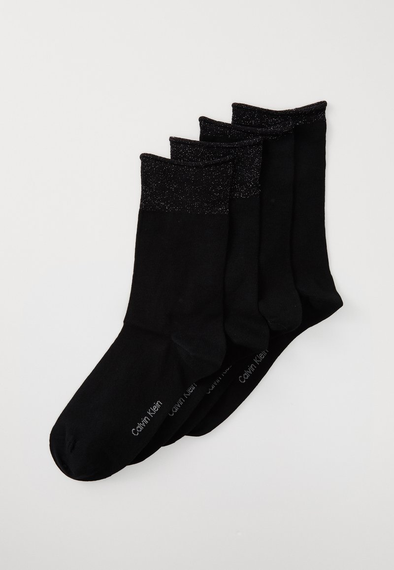 Quatro pares de meias pretas até ao redor do torrent com punhos brilhantes, empilhadas diagonalmente sobre um fundo branco, apresentando um texto de marca subtil na sola.