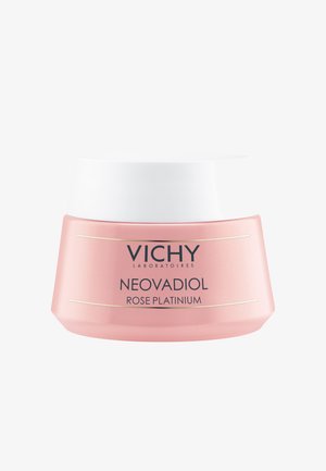Vichy Neovadiol cream in a round, pastel pink jar with a white lid, featuring gold accents and a sleek, modern design.