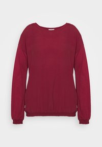 Długi rękaw bordowy sweter z elastycznymi mankietami i dołem, a także szerokim okrągłym dekoltem, na jednolitym jasnym tle.