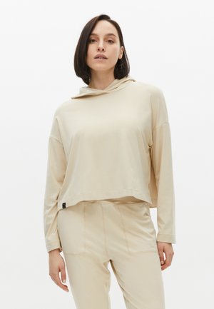 Hoodie beige cropped con cappuccio regolabile, maniche lunghe e vestibilità rilassata. Texture morbida con dettagli di cucitura discreti all'orlo.