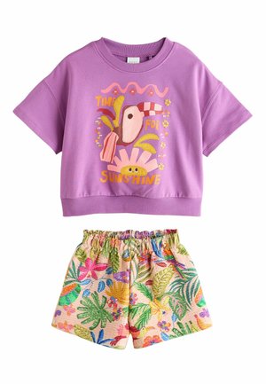Purple short-sleeve top with toucan and "Time for Sunshine" text, paired with elastic waist shorts featuring a colorful tropical floral print.