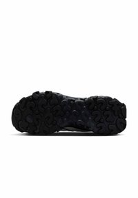 Zwarte rubberen buitenzool met een gestructureerd, golvend patroon voor grip. Het ontwerp beschikt over variërende dieptegroeven voor verbeterde houvast en stabiliteit.