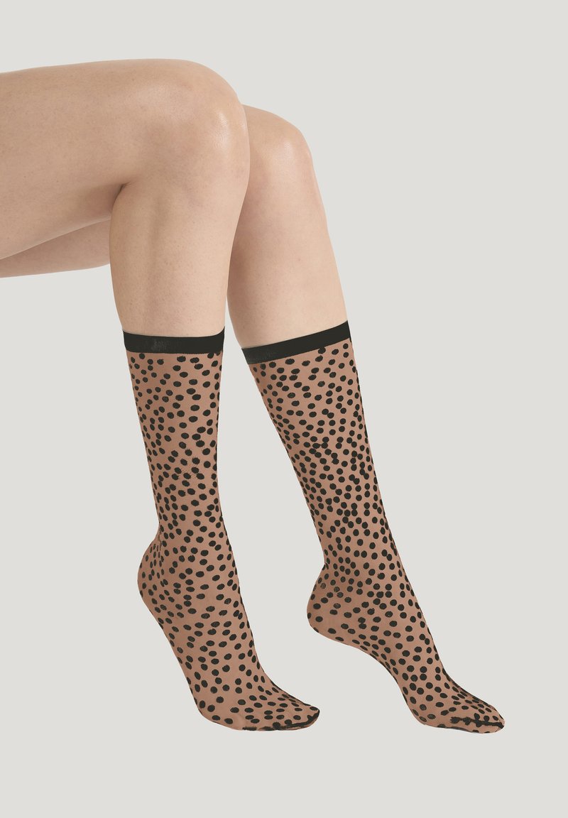 Doorzichtige bruine kniekousen met een zwart stippenpatroon en effen zwarte boorden. Gestructureerde stof en een gladde afwerking.