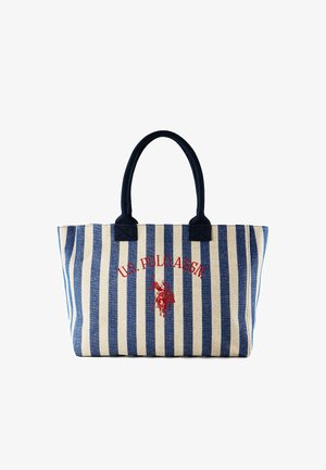 Sac fourre-tout rayé bleu et blanc avec poignées bleu marine, présentant un logo rouge de U.S. Polo Assn. et un emblème brodé de joueur de polo sur le devant.