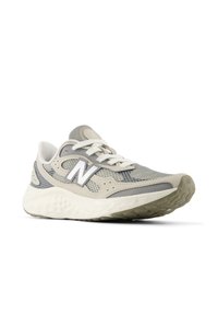 Gray mesh running shoe with a textured upper, light gray accents, white laces, and a cushioned, patterned sole. Features New Balance logo.
