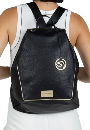 Black leather backpack with a textured surface, gold-tone hardware, drawstring closure, and logo accent at the front. Adjustable straps.