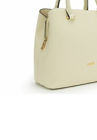 Cream leather handbag with a structured shape, gold-tone hardware, zip closure, and contrasting black lining. Features textured surface and logo detail.