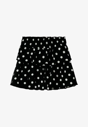 Jupe noire à pois avec un design de volants superposés ; elle possède une taille élastique et des motifs circulaires blancs régulièrement espacés.