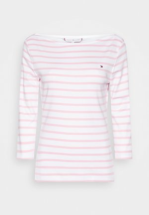 Chemise blanche à manches longues avec des rayures horizontales rose clair et un petit logo Tommy Hilfiger sur la poitrine gauche.