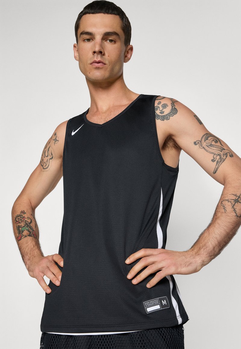 Canotta nera senza maniche con scollo a V, caratterizzata da accenti laterali bianchi e un logo Nike, realizzata in materiale testurizzato e traspirante.